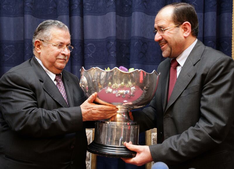 Iraq's President Jalal Talabani, left, and Prime Minister Nuri Al Maliki hold the Asian Cup trophy after the team's return home on August 3, 2007. Reuters