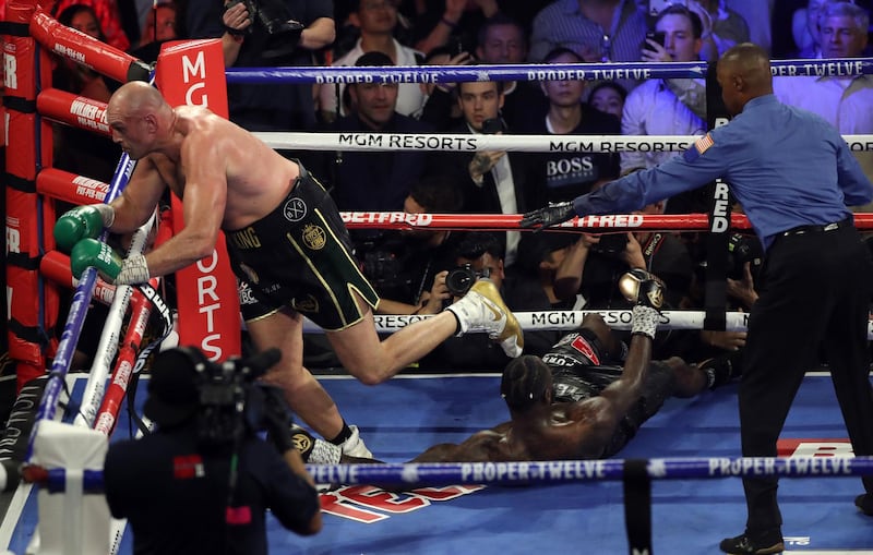 Tyson Fury knocks down Deontay Wilder.