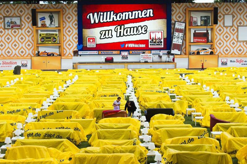 Early arrivals uncover their sofa to watch a 2014 World Cup match at a public viewing event at Berlin's Alte Forsterei stadium. home to Union Berlin, of the German second division, who have turned their stadium into a giant 'World Cup living room'. Thomas Peter / Reuters