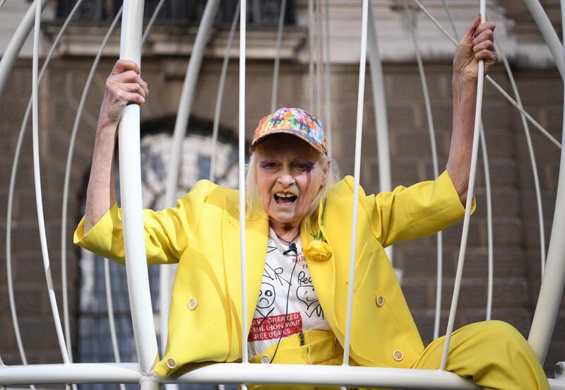 British fashion designer Vivienne Westwood poses in a cage to protest the extradition of Wikleaks founder Julian Assange at the Central Criminal Court, commonly known as The Old Bailey in London on Tuesday. EPA