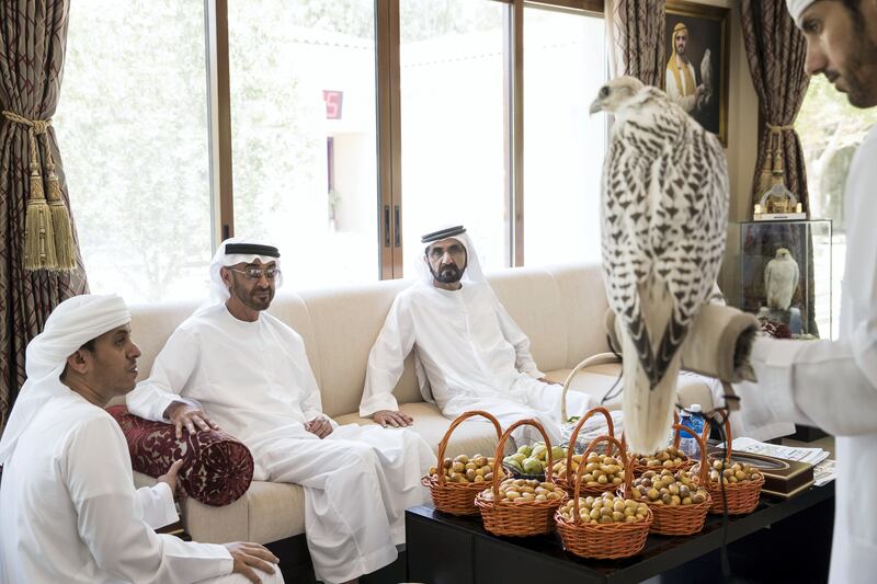 AL MARGHAM, DUBAI, UNITED ARAB EMIRATES - August 09, 2017: HH Sheikh Mohamed bin Zayed Al Nahyan, Crown Prince of Abu Dhabi and Deputy Supreme Commander of the UAE Armed Forces (2nd L), looks at a falcon during a lunch reception hosted by HH Sheikh Mohamed bin Rashid Al Maktoum, Vice-President, Prime Minister of the UAE, Ruler of Dubai and Minister of Defence (3rd L). 
( Ryan Carter / Crown Prince Court - Abu Dhabi )
---