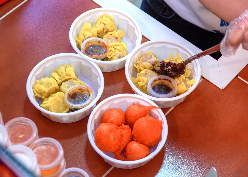 Kwek kwek, orange quail eggs, and siomai, Filipino dumplings with garlic chilli sauce in extra virgin olive oil.