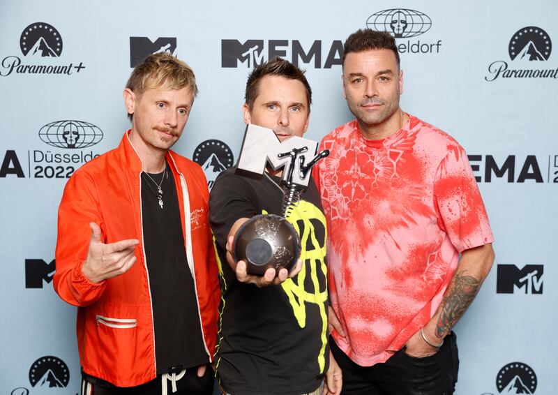 From left, Muse bandmates Dominic Howard, Matthew Bellamy and Chris Wolstenholme celebrated their Best Rock award. Getty Images