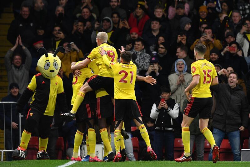 Deeney celebrates with teammates. AFP