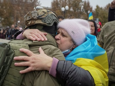 A resident hugs a Ukrainian soldier as people celebrate after Russia's retreat from Kherson on Friday. Reuters