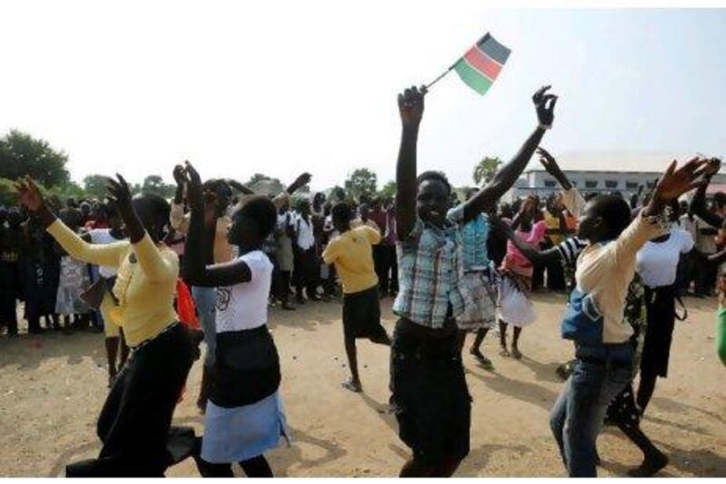 A schoolgirl waves a South Sudanese flag as students practise their routine for independence celebrations in Juba.
