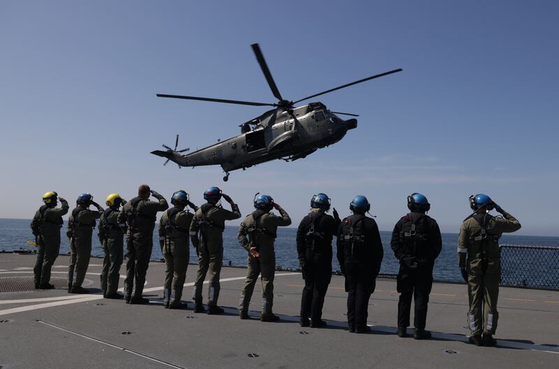 German sailors salute as the helicopter carrying Chancellor Olaf Scholz leaves a navy frigate in the Baltic Sea. Getty