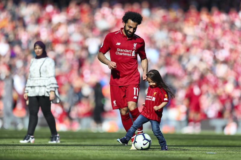 LIVERPOOL, ENGLAND - MAY 12: Mohamed Salah of Liverpool walks around his pitch with his child after the Premier League match between Liverpool FC and Wolverhampton Wanderers at Anfield on May 12, 2019 in Liverpool, United Kingdom. (Photo by Catherine Ivill/Getty Images)