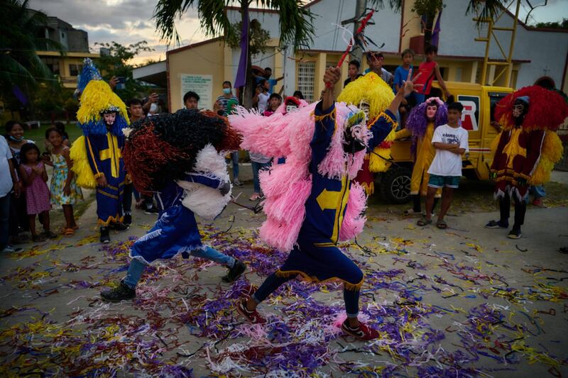 Catholic devotees dressed in costumes representing Roman soldiers prepare to join a procession of the dead Christ, during Holy Week, in Catanauan, Philippines. Getty Images