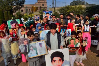 Pakistani families in Peshawar with portraits of their loved ones, who were killed in the 2014 assault by Pakistani Taliban militants on the Army Public School in Peshawar, on December 14, 2021. AP