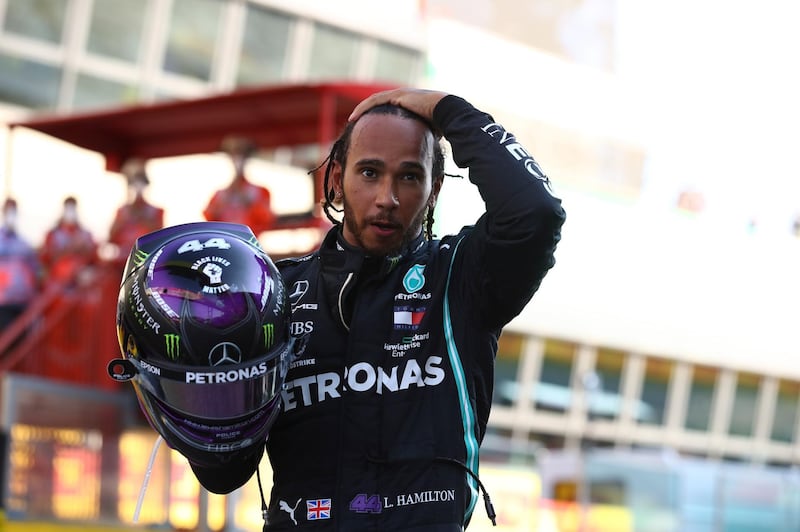 epa08666806 British Formula One driver Lewis Hamilton of Mercedes-AMG Petronas reacts after winning the Formula One Grand Prix of Tuscany at the race track in Mugello, Italy 13 September 2020.  EPA/Bryn Lennon / Pool
