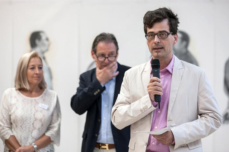 Museum Director Peter Stohler at the opening of the exhibition “There Are Too Many Walls But Not Enough Bridges”, July 26, 2015, with organizers Heidi and Franz Leupi (back) (Courtesy: ORYX Foundation)