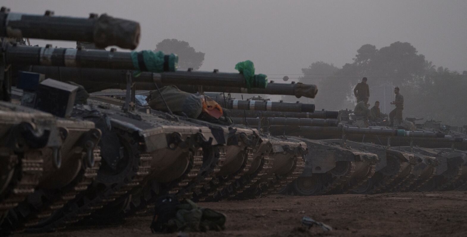 Israeli soldiers stand on top of a tank in a staging area at the Israeli-Gaza border in southern Israel, Monday, Jan.  1, 2024.  The army is battling Palestinian militants across Gaza in the war ignited by Hamas' Oct.  7 attack into Israel.  (AP Photo / Leo Correa)