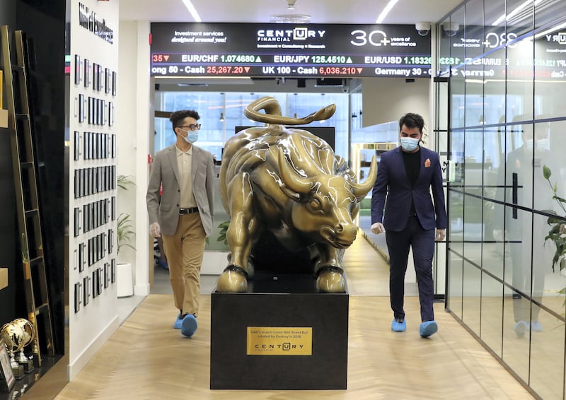 Dubai, United Arab Emirates - Reporter: N/A. Standalone. Covid-19/Coronavirus. Colleagues Shubham and Xieraili (L) chat at Century Financial. Employees are required to wear masks, gloves and over shoes. Thursday, August 27th, 2020. Dubai. Chris Whiteoak / The National