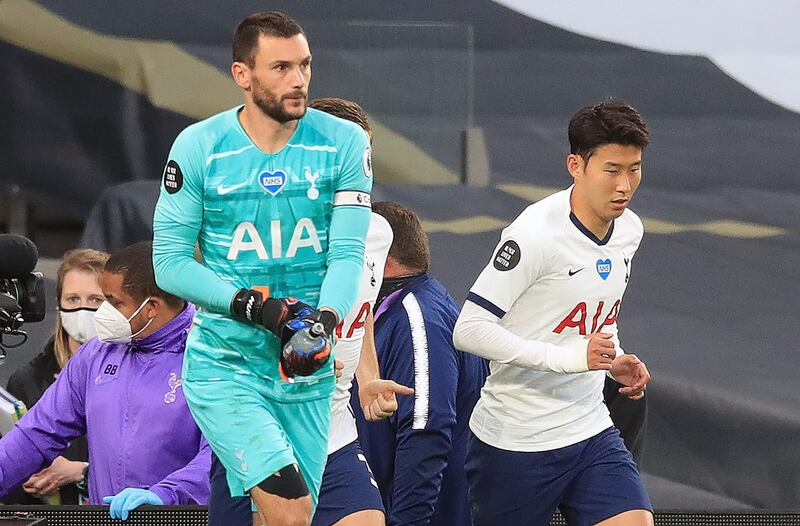 Tottenham goalkeeper Hugo Lloris (L) and striker Son Heung-Min arrive for the second half minutes after their clash during the match against Everton. AFP