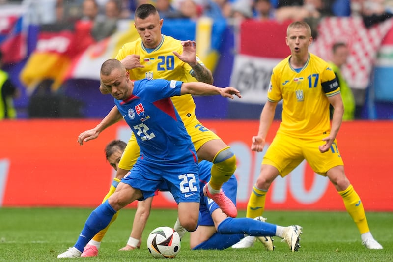 Slovakia's Stanislav Lobotka vies for the ball with Ukraine's Oleksandr Zubkov. AP