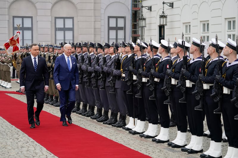 Mr Biden inspects a guard of honour with Mr Duda at the Presidential Palace. AP
