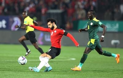 Egypt's Mohamed Salah, left, under pressure from Liverpool teammate Sadio Mane of Senegal during the World Cup qualifier on Tuesday. EPA 