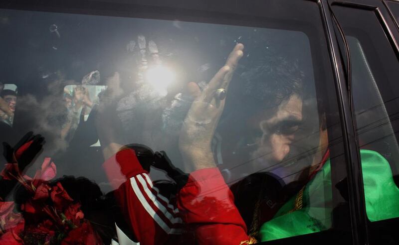 Players of the Afghan team wave to fans. S Sabawoon / EPA