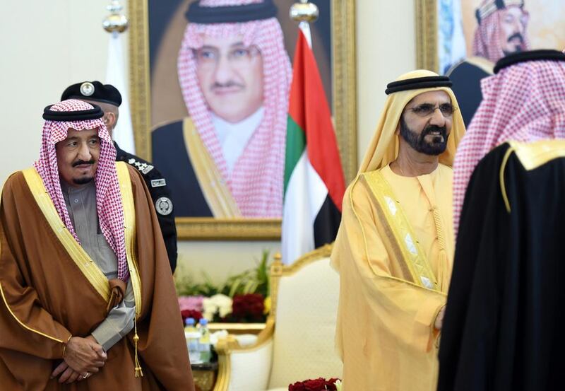 Sheikh Mohammed bin Rashid, Vice President and Ruler of Dubai, greets Saudi officials in the presence of King Salman of Saudi Arabia, left, at the 136th Gulf Cooperation Council summit in Riyadh on Wednesday. Fayez Nureldine / AFP