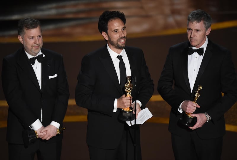 Greg Butler, from left, Guillaume Rocheron and Dominic Tuohy accept the award for best visual effects for '1917' at the 92nd Academy Awards on Sunday, February 9. AP