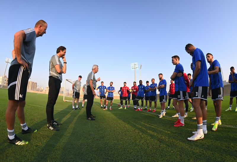 UAE manager Bert van Marwijk speaks to the players during the training session.
