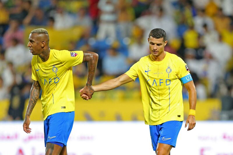 Al Nassr's Portuguese forward Cristiano Ronaldo with Brazilian forward Talisca. AFP