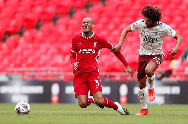 Liverpool's Fabinho goes down after a challenge by Mohamed Elneny of Arsenal. Getty