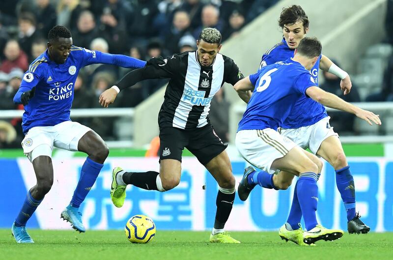 NEWCASTLE UPON TYNE, ENGLAND - JANUARY 01: Joelinton of Newcastle United collides with Leicester City players during the Premier League match between Newcastle United and Leicester City at St. James Park on January 01, 2020 in Newcastle upon Tyne, United Kingdom. (Photo by Mark Runnacles/Getty Images)