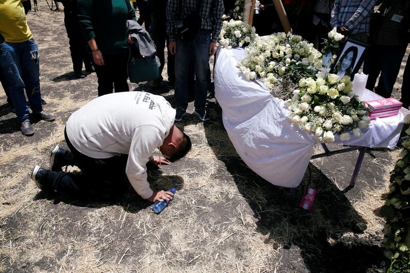 A Chinese man mourns a victim of the Ethiopian Airlines Flight ET 302 plane crash during a commemoration ceremony at the scene of the crash, near the town of Bishoftu, southeast of Addis Ababa, Ethiopia. Reuters