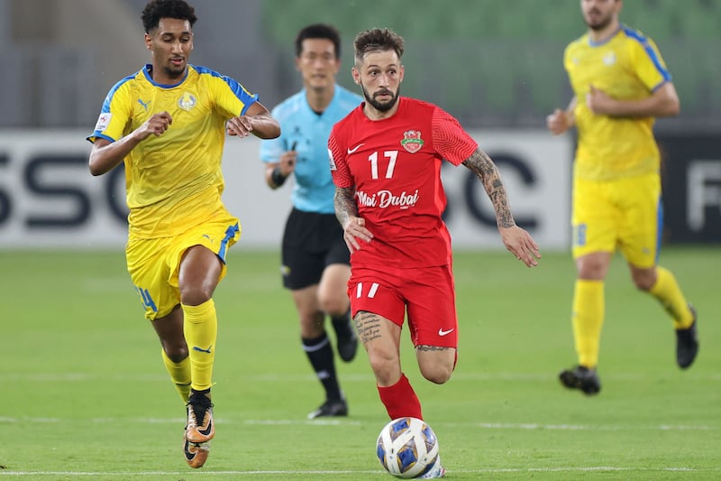 Federico Cartabia runs with the ball as Al Gharafa defender Homam Ahmed attempts to chase him down. AFP