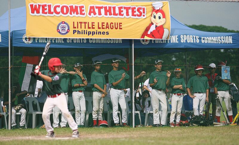 Clarke Philippines, July 3 2013, Asian Pacific Middle East Playoffs, Paul Radley Story- Team UAE Line the dugout fence as (left Hayden Davidson bats) . The UAE was eliminated and did not playi in the  Asian Pacific  Middle East Little League Regional Finals. Mike Young For The National