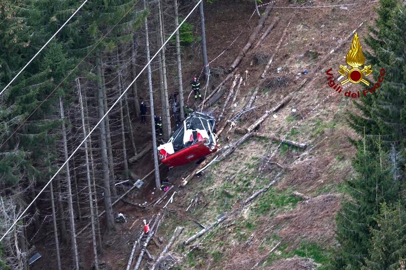 A photo grabbed from an aerial video taken and handout on May 23, 2021 by The Italian Firefighters "Vigili del Fuoco" shows rescuers working by a cable car that crashed to the ground in the resort town of Stresa on the shores of Lake Maggiore in the Piedmont region. 13 people died and two children were seriously injured Sunday after a cable car crashed to the ground in northern Italy, emergency services said. - RESTRICTED TO EDITORIAL USE - MANDATORY CREDIT "AFP PHOTO / VIGILI DEL FUOCO / HANDOUT " - NO MARKETING - NO ADVERTISING CAMPAIGNS - DISTRIBUTED AS A SERVICE TO CLIENTS
 / AFP / Vigili del Fuoco / Handout / RESTRICTED TO EDITORIAL USE - MANDATORY CREDIT "AFP PHOTO / VIGILI DEL FUOCO / HANDOUT " - NO MARKETING - NO ADVERTISING CAMPAIGNS - DISTRIBUTED AS A SERVICE TO CLIENTS
