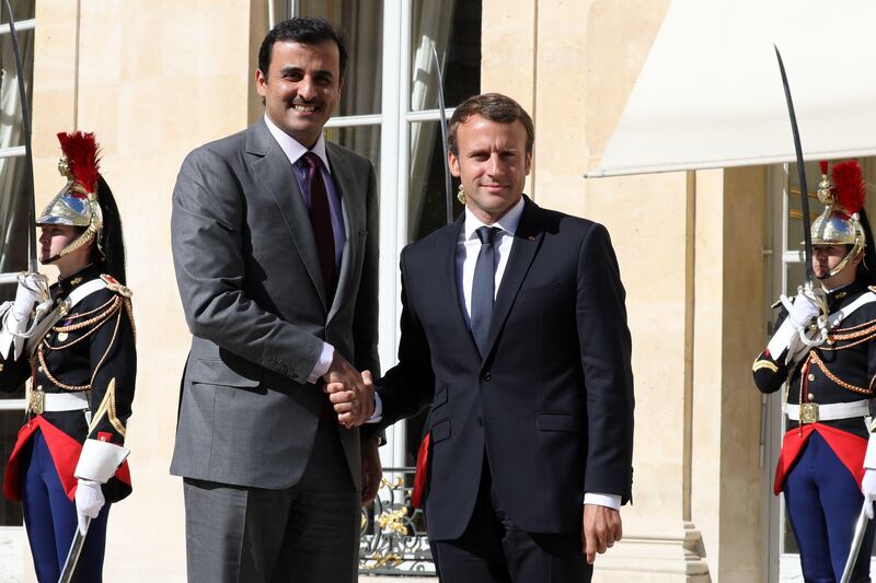 French President Emmanuel Macron shakes hands with Qatar's Emir Sheik Tamim bin Hamad al-Thani upon his arrival at the Elysee palace for a meeting on September 15, 2017, in Paris. / AFP PHOTO / ludovic MARIN