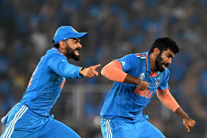 India's Jasprit Bumrah, right, celebrates with teammate Virat Kohli after taking the wicket of Australia's Steve Smith. AFP