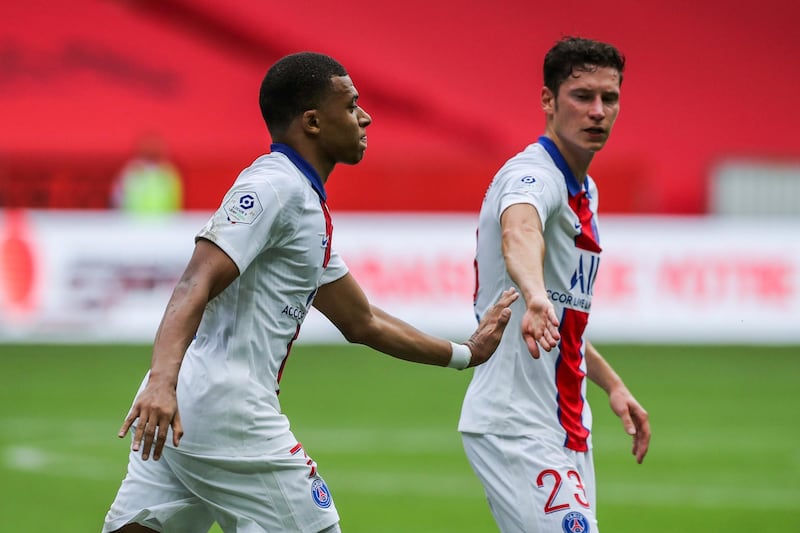 PSG's Kylian Mbappe, left, is congratulated by teammate Julian Draxler after scoring the opening goal on Sunday. AP