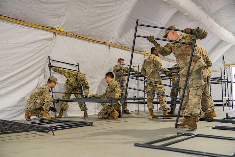 US Army soldiers work together to set up cots at Camp Kasserine for the arrival of citizens from Afghanistan who will lodge at Grafenwoehr Training Area, Germany. Reuters