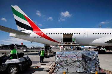 An Emirates Airlines Boing 777 plane unloads a coronavirus vaccine shipment at Dubai International Airport on February 1, 2021. AFP