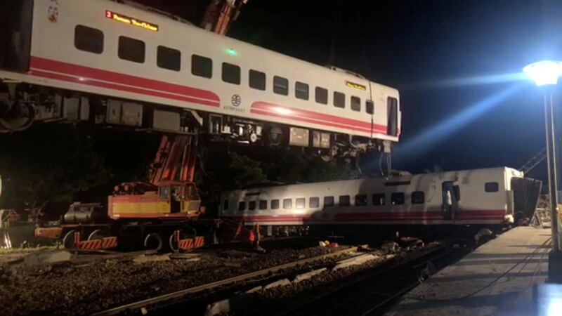 A crane lifts a train which had overturned in Yilan County, Taiwan.  REUTERS