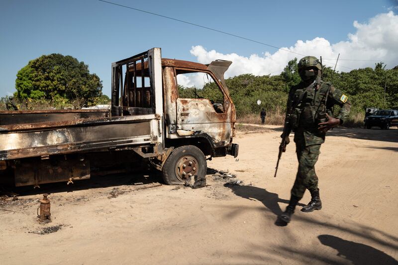 A Rwandan soldier walks in front of a burned truck near Palma, Cabo Delgado, Mozambique last September. AFP