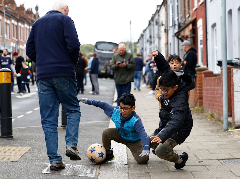Children play football outside Kenilworth Road, home to Luton Town, before the Premiership side's match with Brentford. Luton remain in the relegation zone after losing by 1-5, while Brentford rise to mid-table safety. Reuters