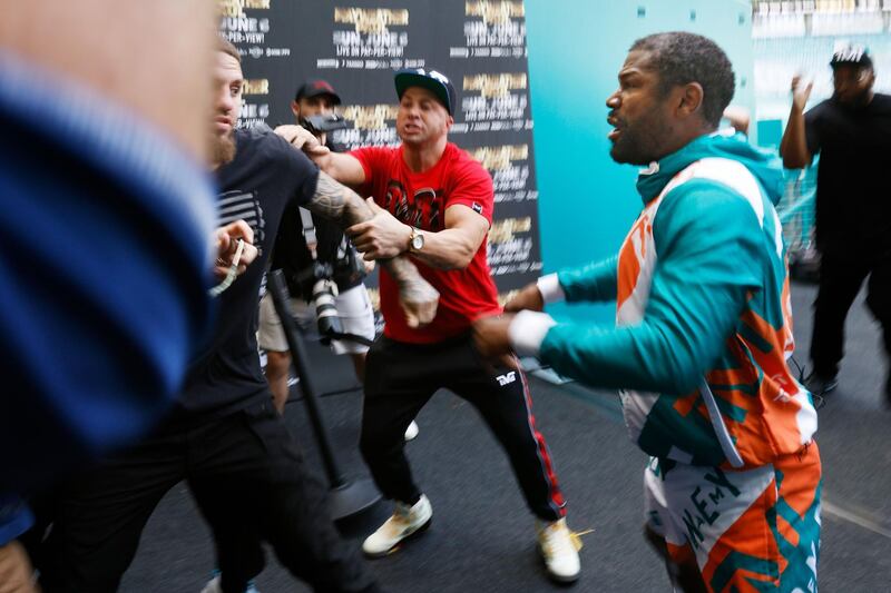 Floyd Mayweather and Jake Paul scuffle after Paul took Mayweather's hat during a media day for Mayweather's fight against Logan Paul. AFP
