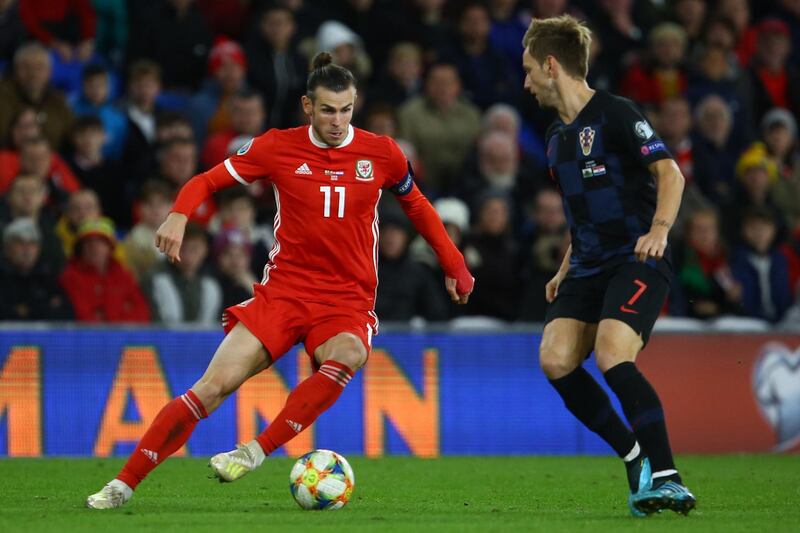 Wales striker Gareth Balem left, dribbles past Croatia midfielder Ivan Rakitic during the Euro 2020 qualifier at Cardiff City Stadium. The match ended 1-1. AFP
