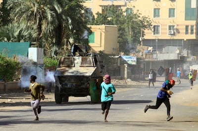 Demonstrators flee security forces following the signing of a deal between military rulers and a major pro-democracy coalition. AFP