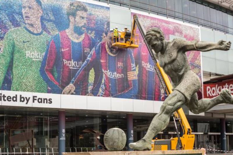 Lionel Messi is removed from a poster at the Barcelona's Camp Nou on August 10 after it was announced that the Argentine was leaving the Spanish club. Getty