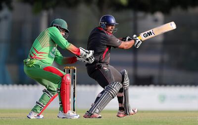 
DUBAI , UNITED ARAB EMIRATES , NOV 16   – 2017 :-  Ashfaq Ahmed of UAE team playing a shot during the one day international cricket match against Zimbabwe A team at the ICC Academy in Dubai Sports City in Dubai. Also seen in the photo Peter Moor wicket-keeper of Zimbabwe A team. (Pawan Singh / The National) Story by Paul Radley
