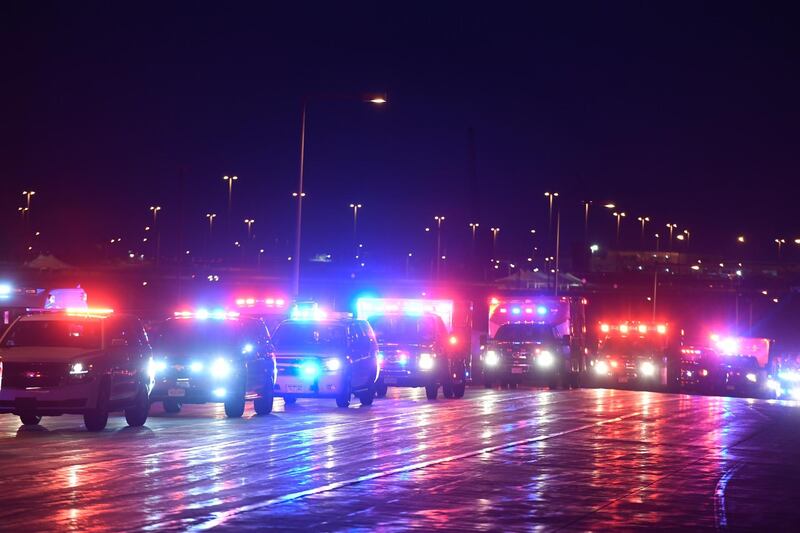 The procession of emergency vehicles for retired paramedic Paul Cary makes its way out of Denver International Airport, 2020m, in Denver. Cary died from coronavirus after volunteering to help combat the pandemic in New York City.  AP