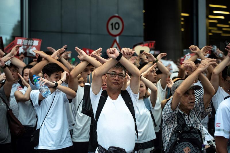 Protesters gesture as they chant "no extradition" as they rally against a controversial extradition law proposal in Hong Kong on June 9 2019. AFP