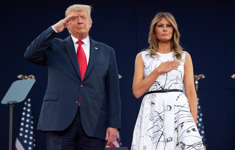 US President Donald Trump and First Lady Melania Trump pay their respects as they listen to the National Anthem during the Independence Day events at Mount Rushmore National Memorial. AFP