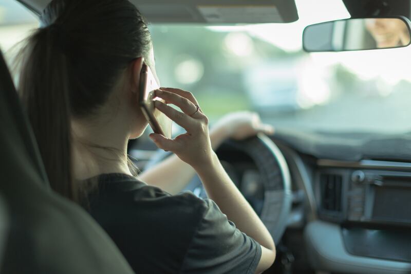 Using a mobile phone behind the wheel is punishable with four black points. Getty Images